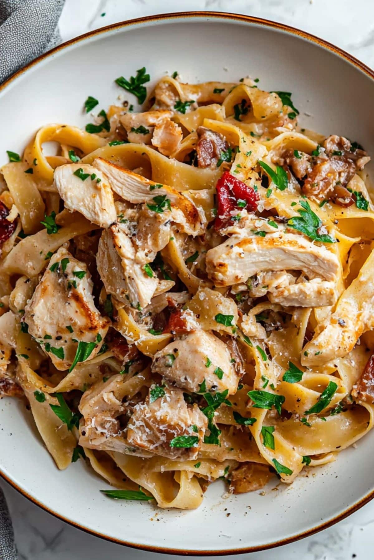# Chicken Boscaiola Pasta ### Introduction: Indulge in the rich and flavorful Chicken Boscaiola Pasta that is not only delicious but also easy to make. This dish is perfect for a cozy dinner with loved ones or a quick weeknight meal. ### Why You’ll Love This Recipe? 1. The combination of tender chicken, crispy bacon, and creamy sauce creates a burst of amazing flavors. 2. With simple ingredients and quick prep time, this dish is perfect for busy days or meal prep. 3. The versatility of this recipe allows for ingredient substitutions to suit your taste preferences. ### Ingredient Notes: - Large boneless, skinless chicken breasts: Provide a lean protein base for the dish. - Sweet paprika, sea salt flakes, cracked black pepper: Seasonings that add depth to the flavors. - Olive oil, unsalted butter: Used for cooking the chicken and bacon. - Streaky bacon: Adds a smoky and savory element to the dish. - Small onion, finely diced, finely chopped garlic: Aromatics that enhance the overall taste. - Fettuccine: Traditional pasta choice, but feel free to use your favorite type. - Swiss brown mushrooms: Provide a meaty texture, but white or button mushrooms work as well. - Thickened (heavy) cream, chicken stock powder (bouillon): Create a creamy and rich sauce. - Freshly grated parmesan, flat-leaf parsley: Garnishes that elevate the dish's presentation. ### Step-by-Step Instructions: 1. Season chicken breasts with paprika, salt, and pepper. 2. Cook chicken in olive oil until golden brown, then set aside. 3. In the same skillet, cook bacon until crispy, then add butter, onion, and garlic. 4. Add mushrooms and cook until softened, then pour in cream and chicken stock. 5. Return chicken to the skillet, sprinkle with parmesan, and simmer until sauce thickens. 6. Serve over cooked pasta, garnished with parsley and extra parmesan. ### Helpful Tips: - To enhance the flavors, use quality parmesan cheese and fresh parsley. - For a lighter version, substitute cream with half-and-half or milk. - Store leftovers in an airtight container in the refrigerator for up to 3 days. ### Expert Tips for the Best Results: 1. Sear the chicken over high heat for a crispy exterior and juicy interior. 2. Deglaze the skillet with white wine for an extra depth of flavor. 3. Use a mix of wild mushrooms for a more earthy taste profile. ### Serving Suggestions: Pair this Chicken Boscaiola Pasta with a side salad, garlic bread, and a glass of Chardonnay for a complete meal experience. ### Storage and Reheating Tips: To reheat, gently warm the pasta in a skillet with a splash of cream to prevent drying out. Add a little chicken stock if needed to loosen the sauce. ### Frequently Asked Questions: 1. Can I use chicken thighs instead of chicken breasts? - Yes, chicken thighs can be used for a more flavorful option. 2. What can I substitute for bacon? - Pancetta or ham can be used as alternatives to bacon. 3. Can I freeze this dish? - It is not recommended to freeze pasta dishes with cream-based sauces as they may separate when reheated. 4. How can I make this recipe vegetarian? - Substitute the chicken and bacon with plant-based alternatives like tofu and vegan bacon. ### Conclusion: Try out this Chicken Boscaiola Pasta recipe for a comforting and satisfying meal that is sure to impress your taste buds. Don't forget to share your feedback and enjoy every bite of this delicious dish!